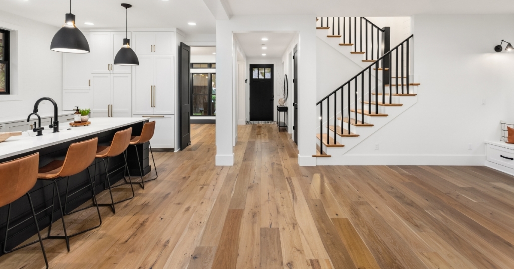 Hardwood flooring installed seamlessly across kitchen and living areas in an open-concept home